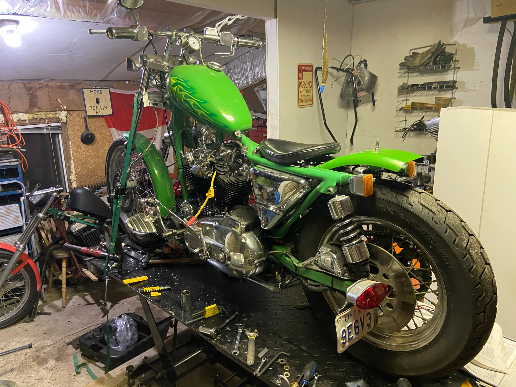 Motorcycle repair in workshop in green